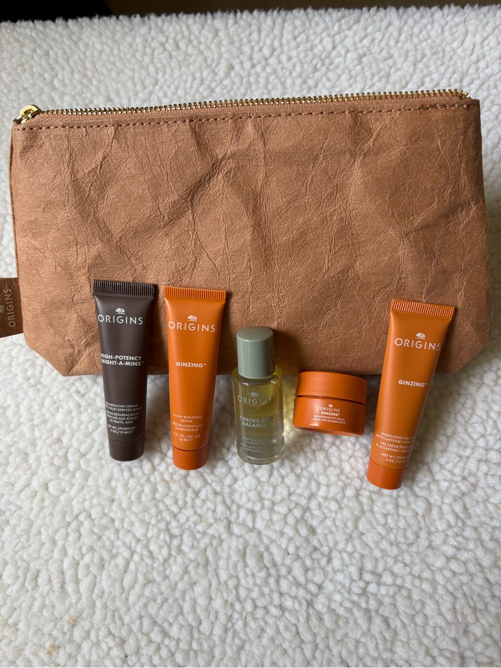 Origins Mini Skincare Set with Orange and Brown Accents